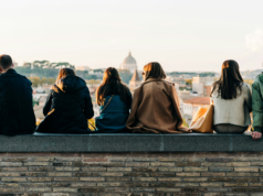 https://unsplash.com/photos/a-group-of-people-sitting-on-top-of-a-brick-wall-o3wZZ9-pPO4